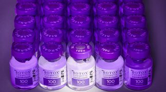 A row of purple bottles sitting on top of each other.