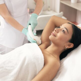 A woman getting her breast waxed at the spa