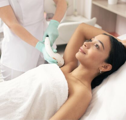 A woman getting her breast waxed at the spa