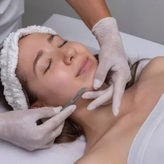 A woman getting her face waxed at the spa