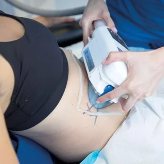 A person is using an ultrasound machine to treat her stomach.