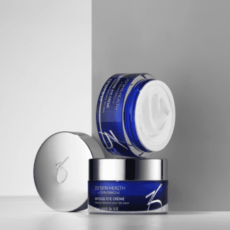A blue jar of skin care sits on top of a white counter.
